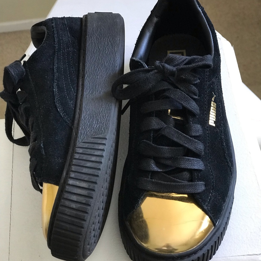 Gold shell toe Pumas.